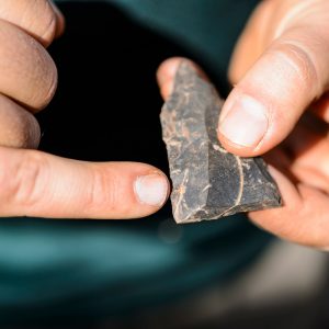 University of the Witwatersrand postdoctoral researcher Matt Caruana points out the hammered-edges of a middle-stone age point